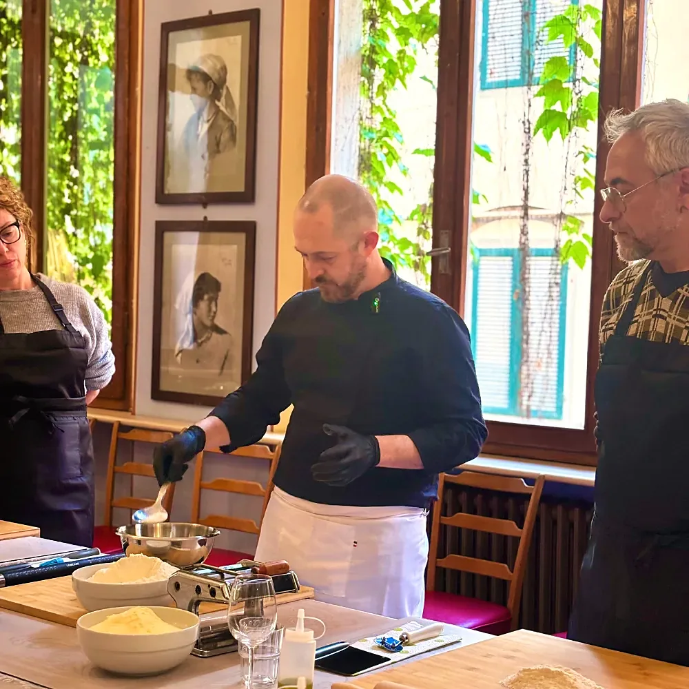 Chef showing guests how to make fresh pasta in a historic room of the Royal Victoria Hotel
