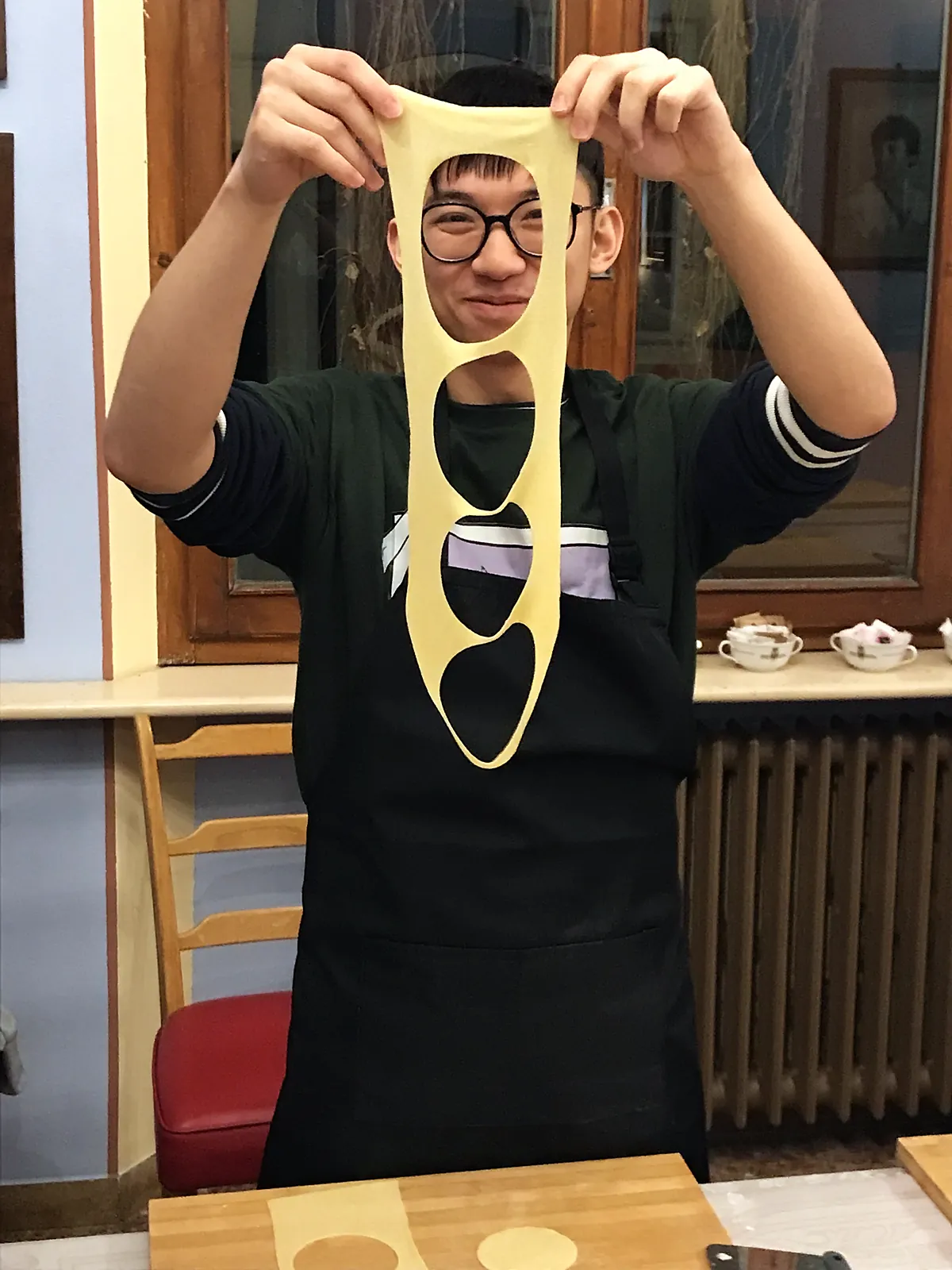 Guest having fun with a sheet of fresh pasta