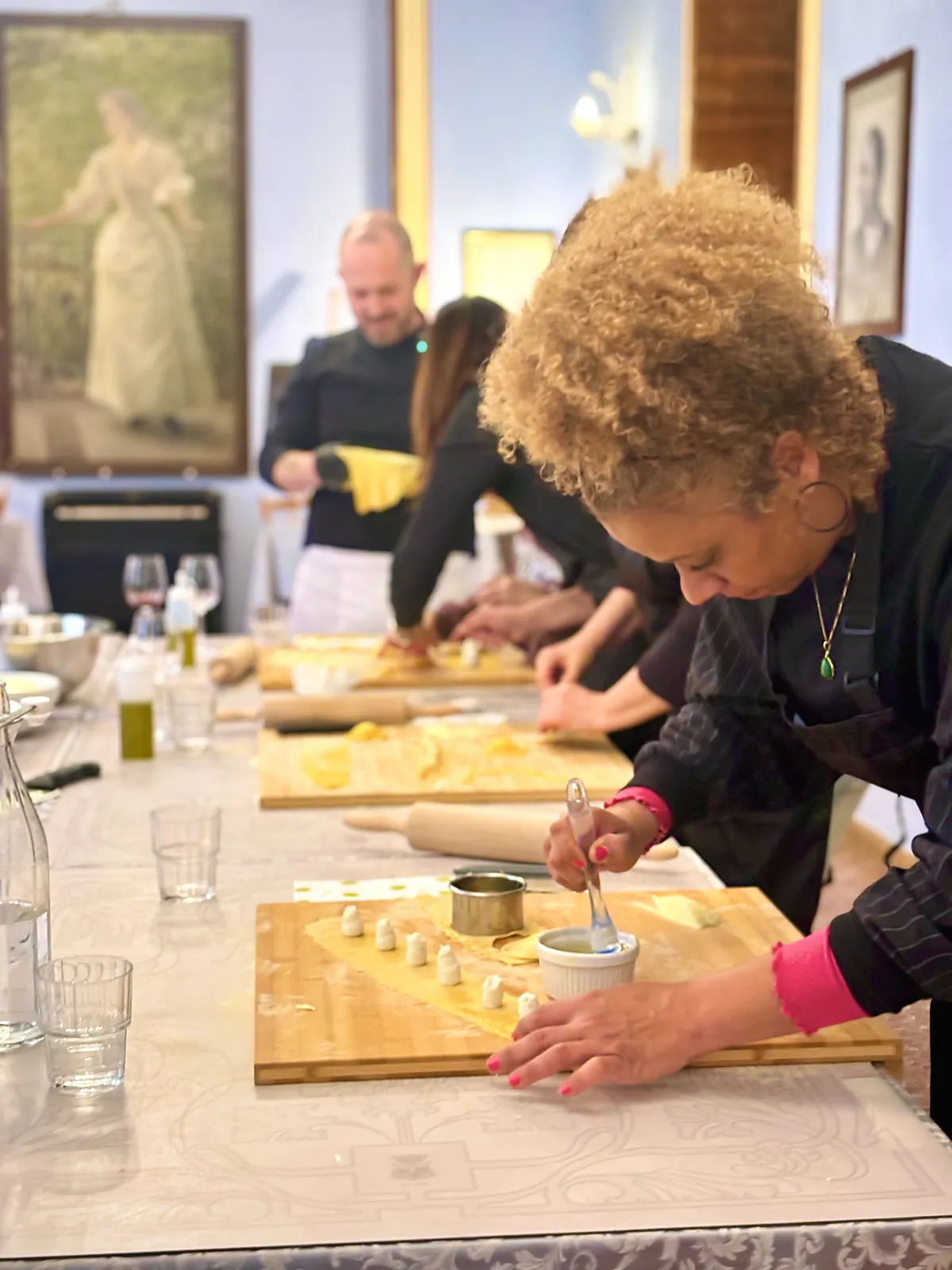 Guest filling fresh pasta under the portraits of the Royal Victoria Hotel